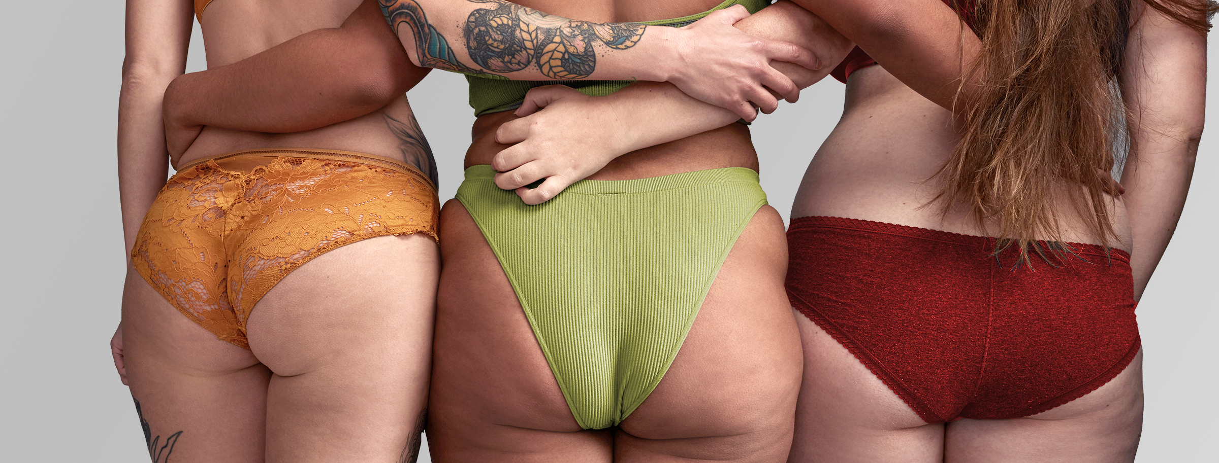 Three perfectly average women in underwear, seen from behind